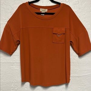 Boxy Orange Top with Crew Neck D-Ring Pocket and Elbow-Length Sleeves